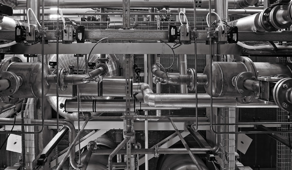 Plumber servicing commercial water heater equipment